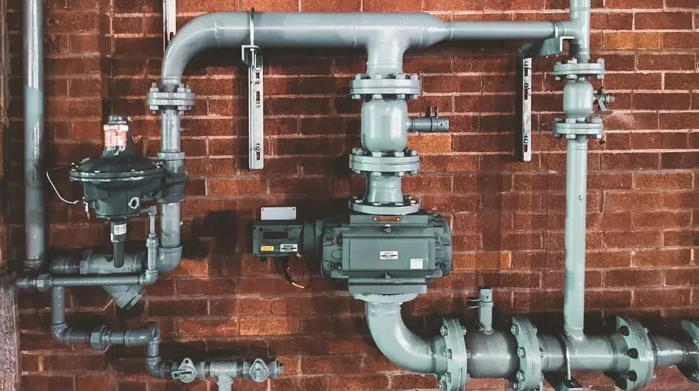 Gas-fired hot water plant pipework in a plant room