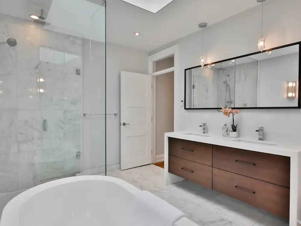 Main ensuite with freestanding bath, frameless shower and timber vanity