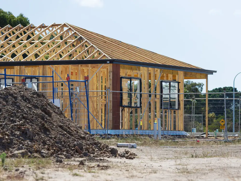 House frame going up on a fenced building site