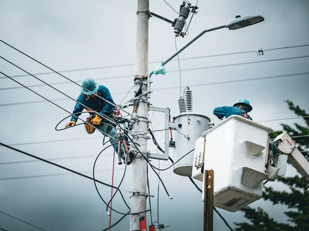 Crews repairing overhead lines on a stormy day