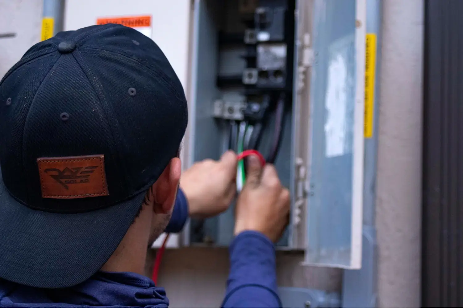 Electrician testing circuits in an open switchboard