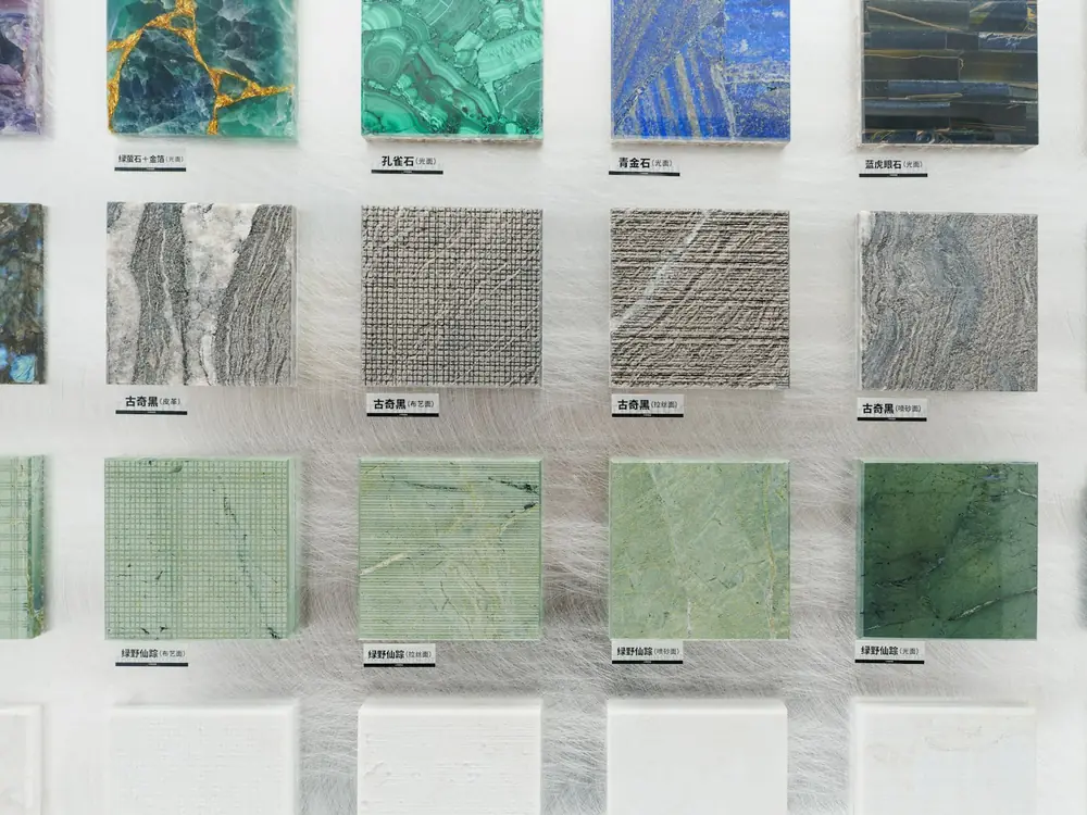 A wall of stone and tile samples at the studio
