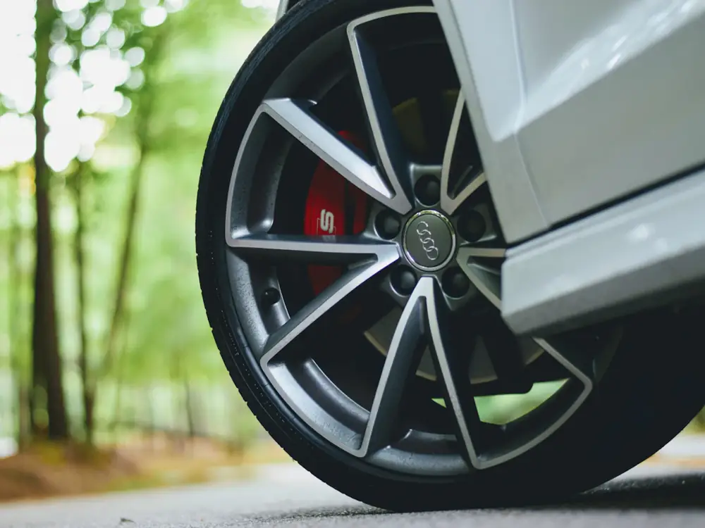 Close-up of a dark alloy wheel with a red brake caliper